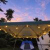 String lights hanging around a camping canopy at dusk, showing the hooks in use. Hooks only; lights and canopy not included.