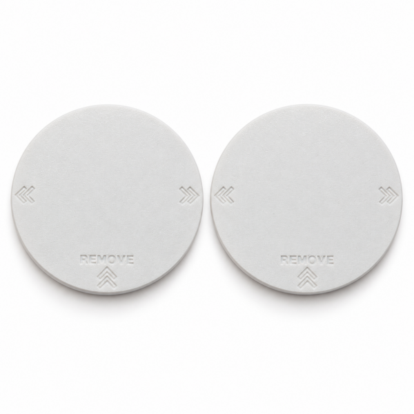 Pair of two white RV AC vent covers with recessed REMOVE lettering and double-chevron markings.