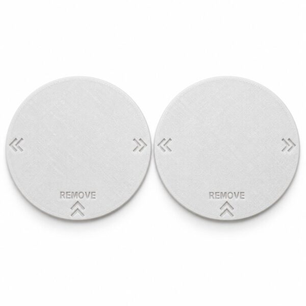Pair of two white RV AC vent covers with recessed REMOVE lettering and double chevrons. Digitally edited product photo.